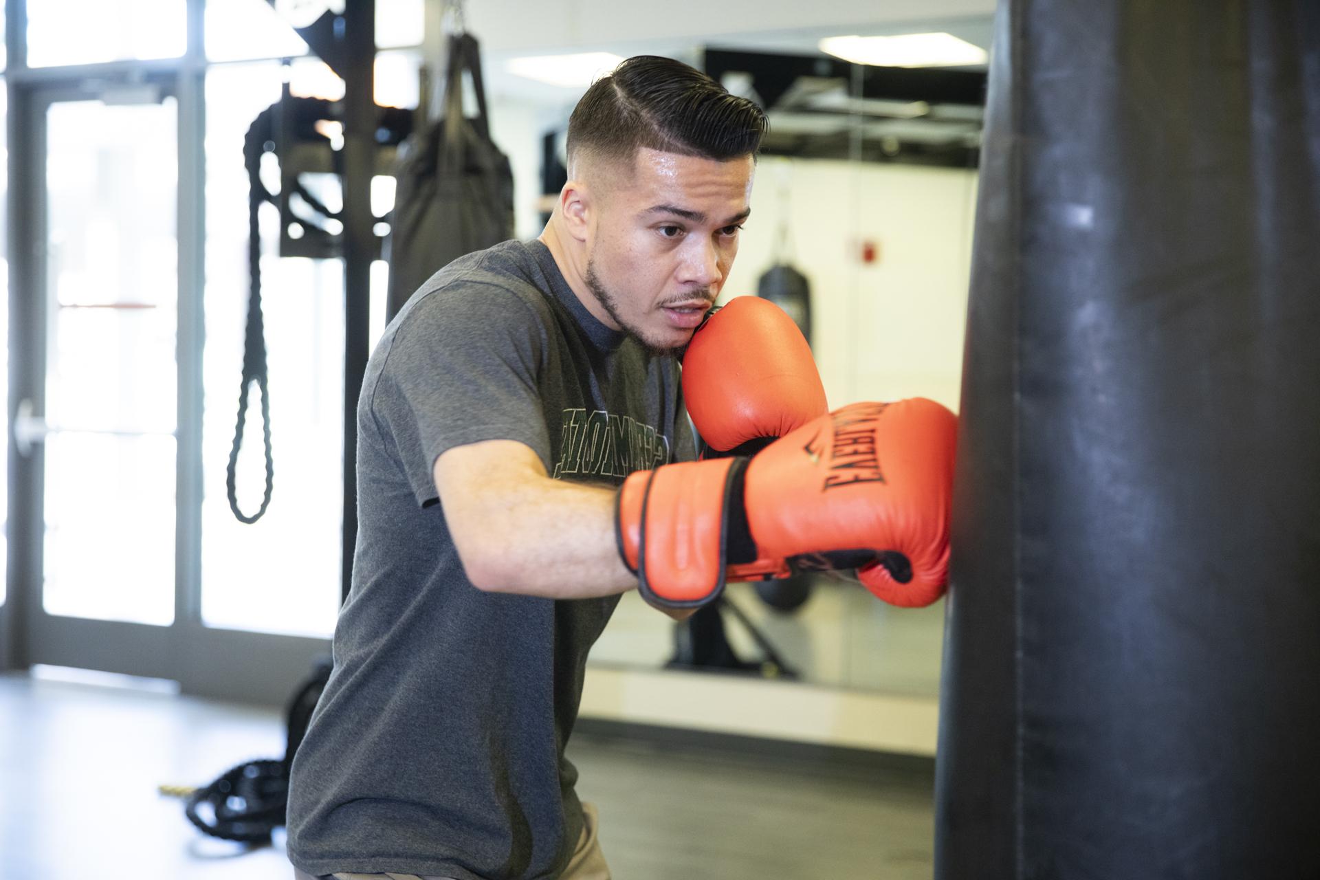 Sac State alumnus and boxer Kevin Montano works out with a punching bag.